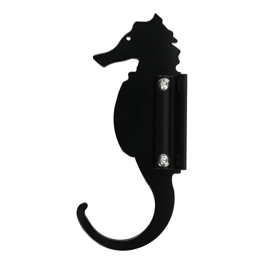 Black seahorse-shaped wall hook isolated on white.