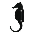 Black seahorse-shaped wall hook isolated on white.