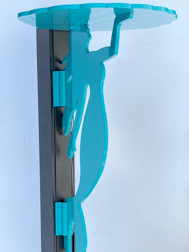 Blue silhouette sculpture with glass shelf against white background.