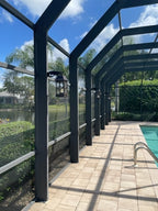 Screened pool area with lanterns and sunny view.