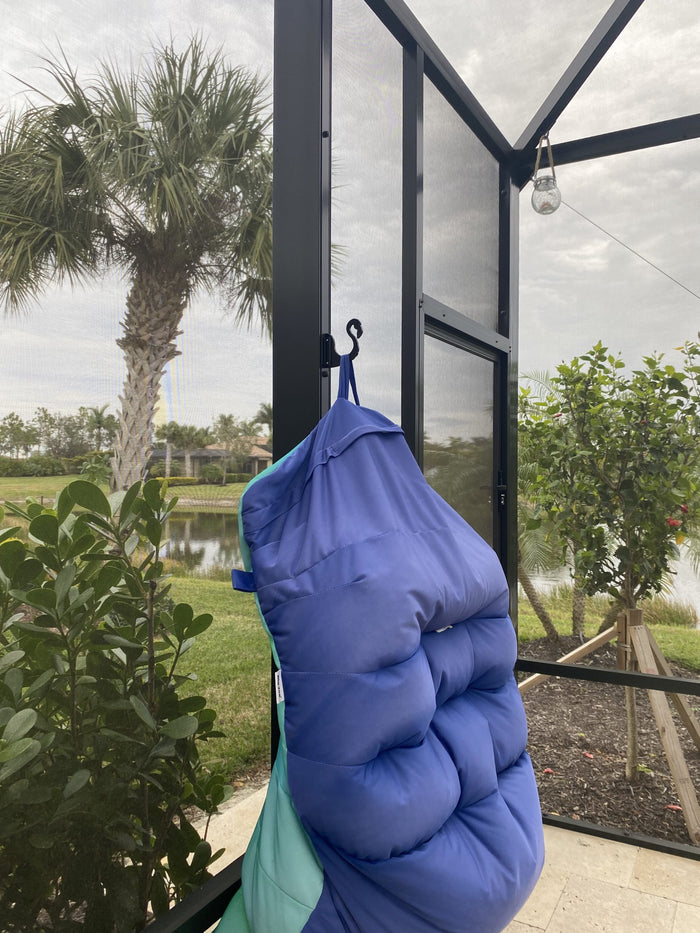 Blue padded float hung on a hook to dry.