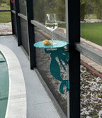 Wine glass on mermaid table by poolside