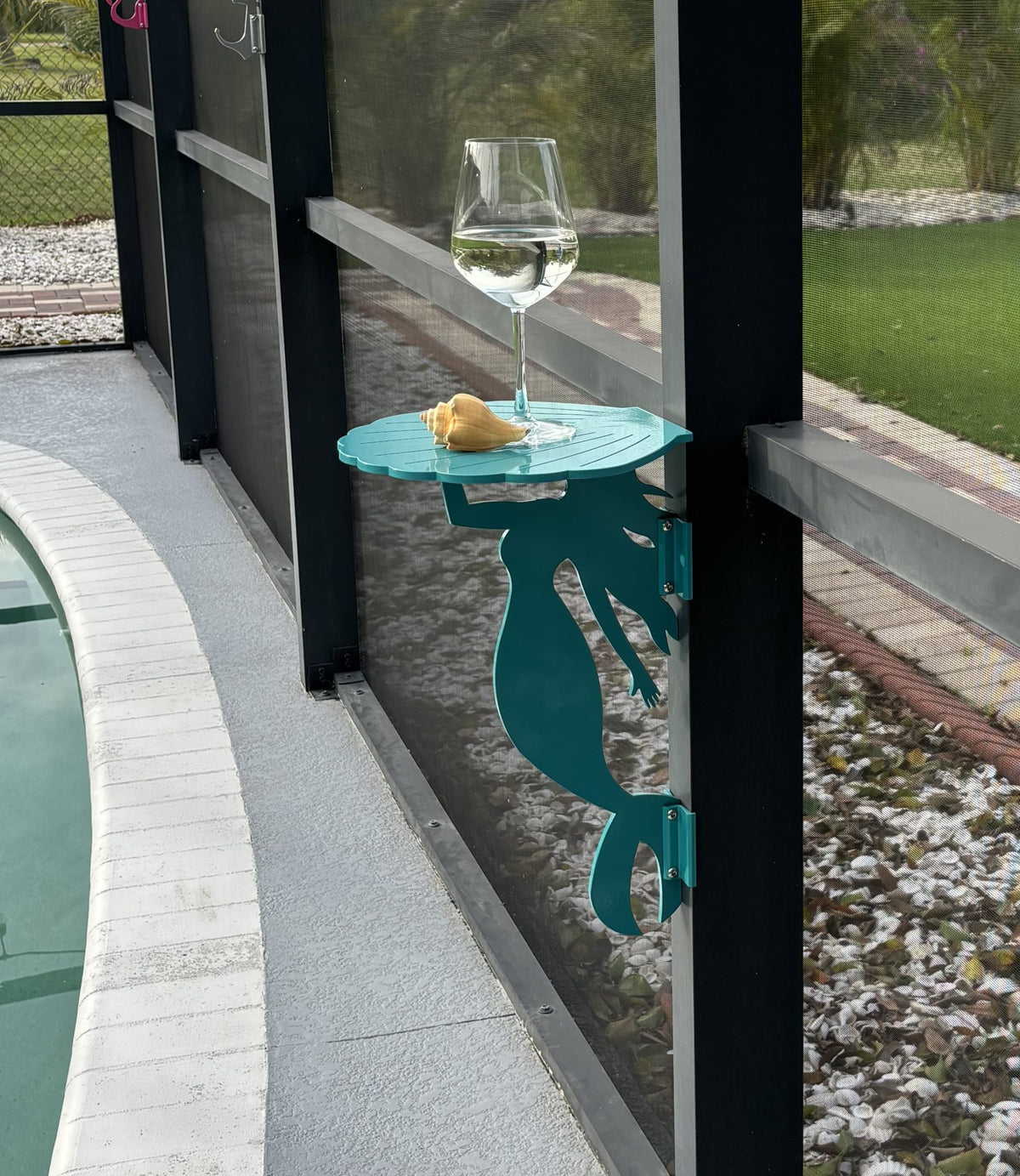 Wine glass on mermaid table by poolside
