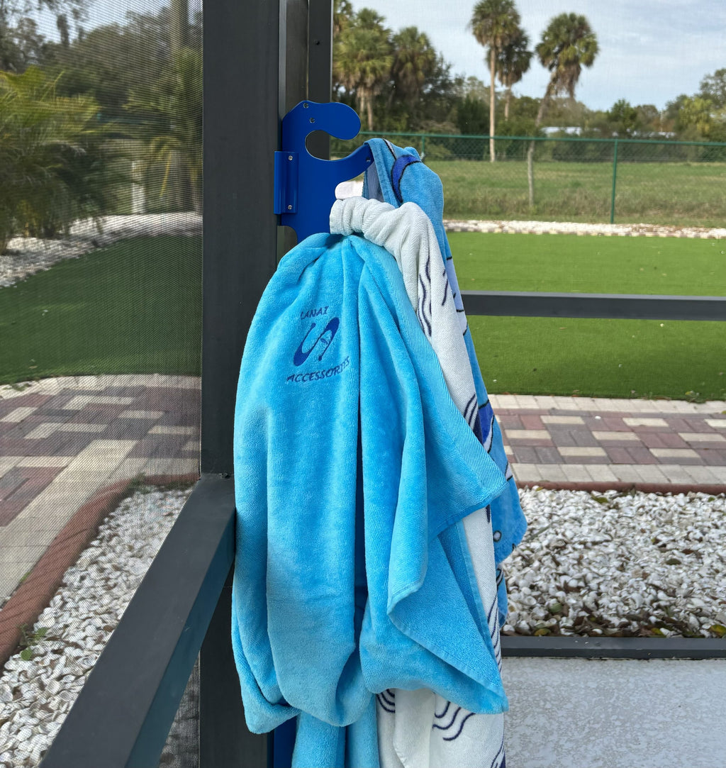 Blue towel hanging on a poolside hook.