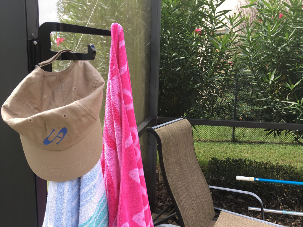 Hat and towels hanging near patio chair
