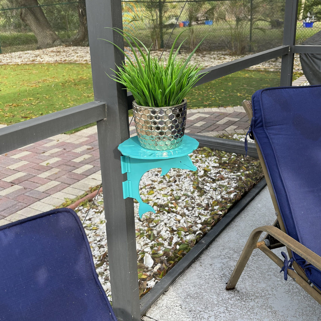 Potted plant on blue side table, screened porch setting.