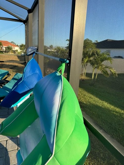 Colorful inflatable pool floats drying outdoors
