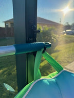Pool skimmer leaning against screened patio.