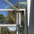 Wind chimes hanging under a pergola with alligator sign.