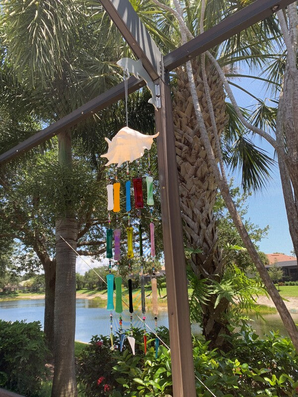 Hanger with wind chime, lake and palms beyond.