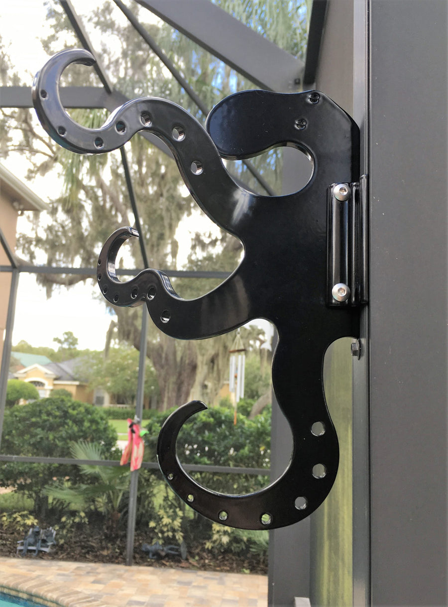 Black octopus hook on dark enclosure post.