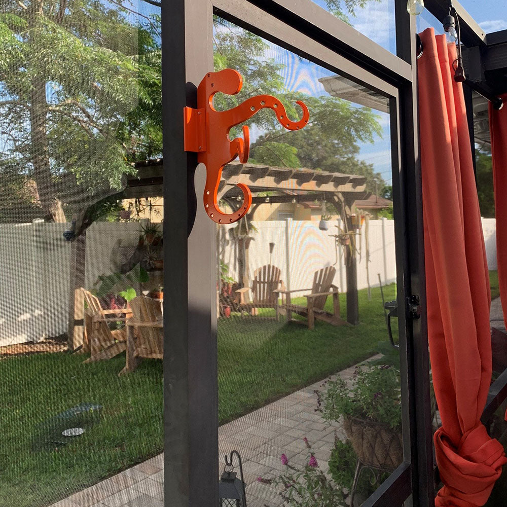 Orange octopus hook on screened patio door.