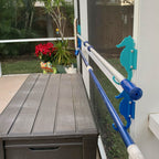 Outdoor pool safety fence with seahorse decorations.